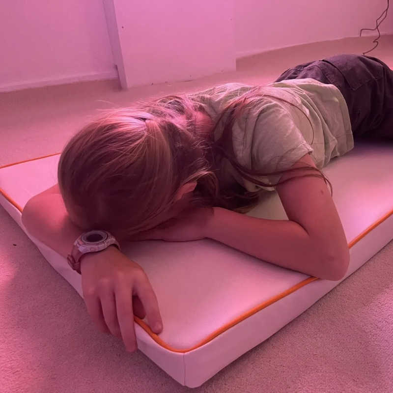 Child resting on TFH Vibrating Floor Pad - Long