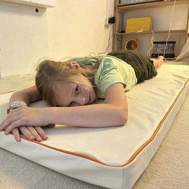 Child relaxing on TFH Vibrating Floor Pad - Long sensory mat
