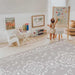 The August Rose Sand Shwally Playmat in a playroom