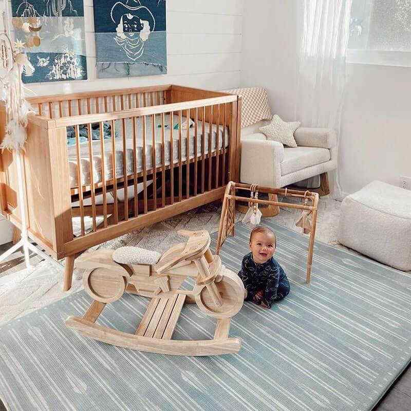 The Bowie Shwally Playmat with a baby in a nursery