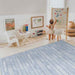 The Bowie Shwally Playmat in a playroom with a toddler drawing