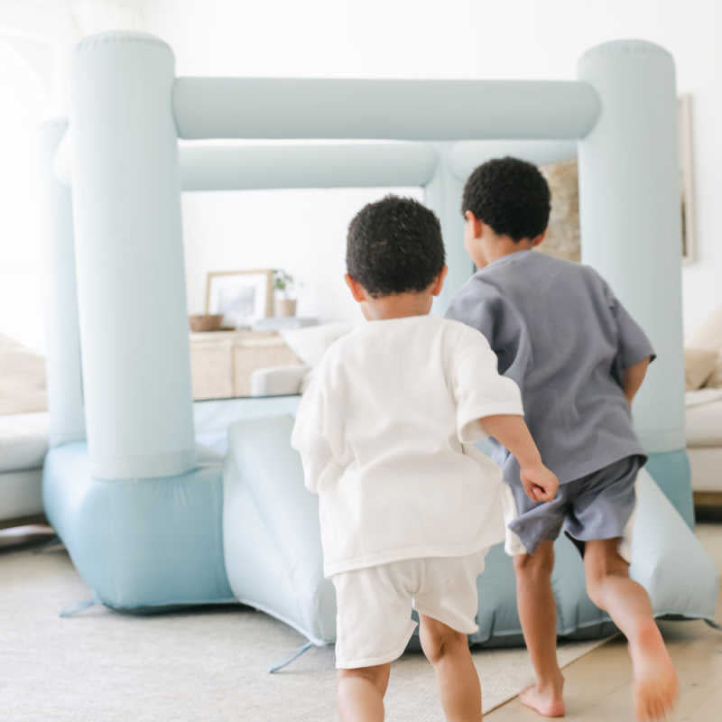 Tumble Blue Bounce House with two boys playing