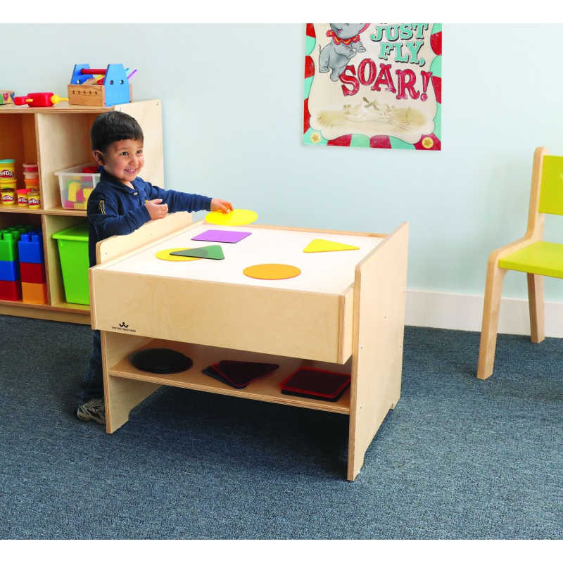 Whitney Brothers® Superbright LED Light Table and Color Wheel Variety Pack with a boy playing with acrylic shapes