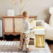 A Young Boy Stands Smiling in Front of the Tiny Land Toy Honey Kitchenett Set
