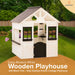 Casa Modern White Wooden Playhouse with black trim in a yard