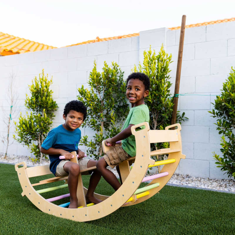 Toddler climbing on Avenlur Bailis Climbing Arch and Rocker for active indoor play
