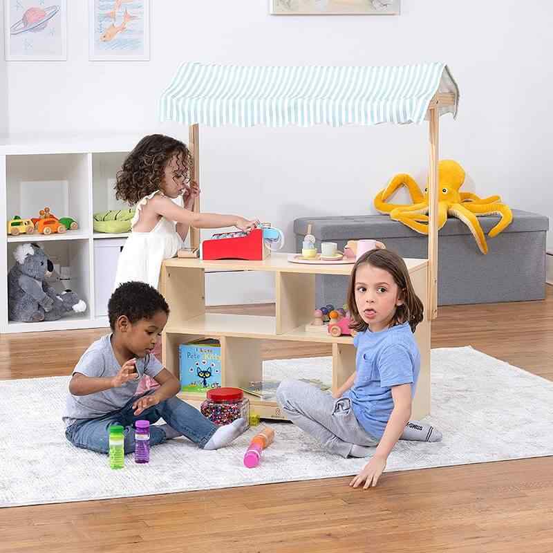 Avenlur Holly Wooden Market Stand – kids using the display shelves for pretend play