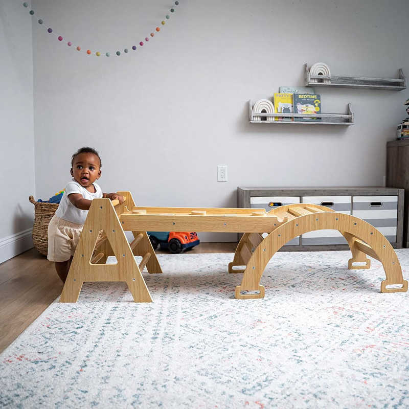 Maple Beginner Pikler Triangle and Rocker with a baby in a playroom