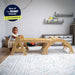 Maple Beginner Pikler Triangle and Rocker with a baby n a playroom