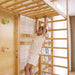 Child using Avenlur monkey bar attachment on 79 inch Modular Walnut Swedish Ladder