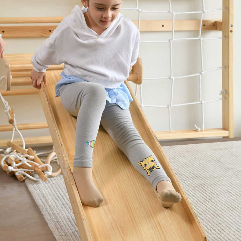 Neem | Swedish Ladder & Rope Wall - 79" Height with a girl sliding 