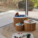Close view of the Avenlur Nesting Fluted Tables with matte white tops and fluted bases