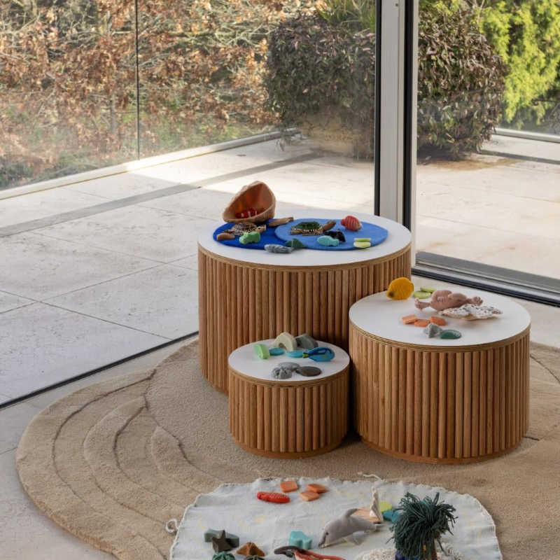 Close view of the Avenlur Nesting Fluted Tables with matte white tops and fluted bases
