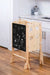 Kid using the chalkboard on the Avenlur Plum 3 in 1 Foldable Kitchen Tower