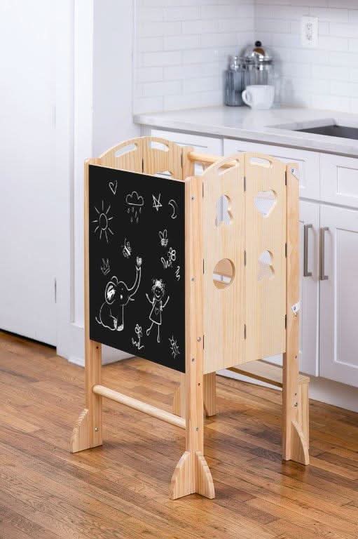 Kid using the chalkboard on the Avenlur Plum 3 in 1 Foldable Kitchen Tower