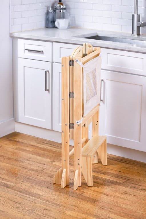 Kid using the Avenlur Plum Foldable Kitchen Tower at a counter