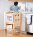 Kid participating in kitchen activities with the Avenlur Plum Foldable Kitchen Tower