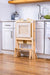 Kid using the Avenlur Plum Foldable Kitchen Tower for everyday routines