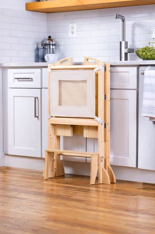 Kid using the Avenlur Plum Foldable Kitchen Tower for everyday routines