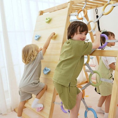 Avenlur Sweetgum XL indoor sensory playset in a bright playroom with kids using the slide and climbing features