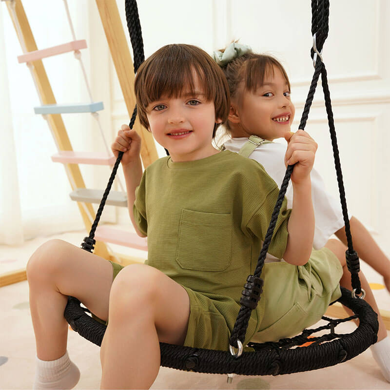 Kids taking turns on the rope swing of the Avenlur Sweetgum XL indoor sensory playset