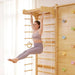 Avenlur 9-in-1 Modular Wall Gym for Children a Woman Doing Swing on a Pull Up Bar