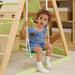 Avenlur Bush 6-in-1 Wooden Climber for Toddlers a Girl Sitting on a Swing