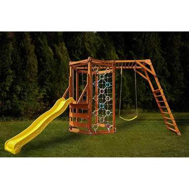 Wooden playground set with yellow slide, swings, monkey bars and climbing structure on grass with trees in the background