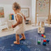 Baby playing with colorful wooden blocks on the Dakota Blue Shwally Playmat