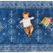 Top view of a baby lying on the Dakota Blue Shwally Playmat