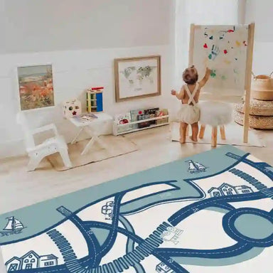 Baby painting beside the road design side of the Dakota Blue Shwally Playmat