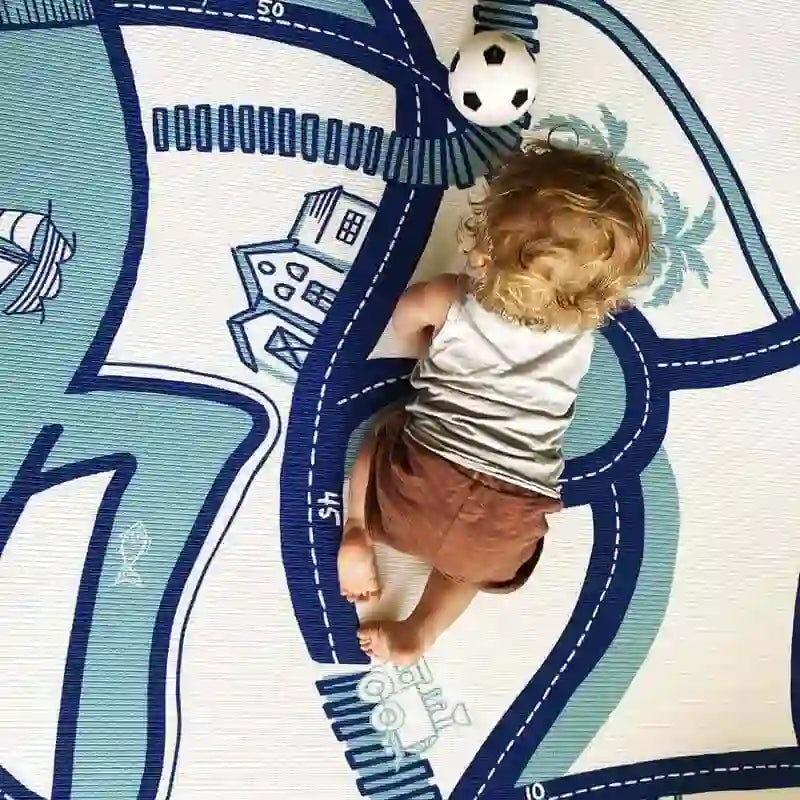 Baby playing on the illustrated reverse side of the Dakota Blue Shwally Playmat