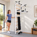 BenchK Wall Bars 723 - teen stretching beside the white frame in a bright home gym
