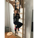 BenchK Gymnastics Accessories A204/A076 – child hanging from light-beech A204 rings on a wooden wall-bar setup, with a rope swing and protective mat