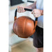 BenchK Leather Kettlebell – person holding the brown leather kettlebell by its metal handle