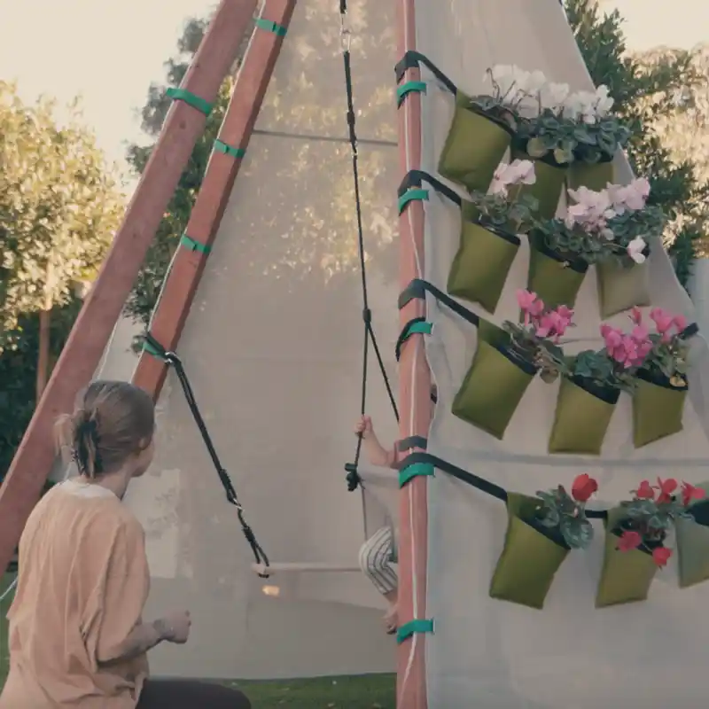 Side view of the Bijou Baby Swing seat and support ropes