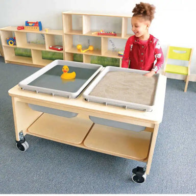 Whitney Brothers Mobile Sensory Play Table With 2 Tubs and Lids (CH4049) – Child playing with water and sand in the two sensory tubs