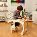 Child Kneling on Kidodido Child Sized Rocking Chair and Activity Table