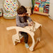 Child Playing With a Wooden Toy in a Kidodido Wooden Rocking Chair Set for Toddlers