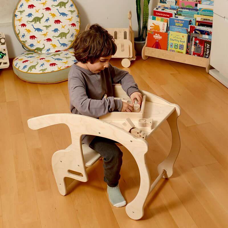 Child Playing With a Wooden Toy in a Kidodido Wooden Rocking Chair Set for Toddlers