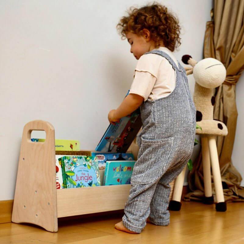 Child Playing With Books in Kidodido Montessori Bookshelf Organizer