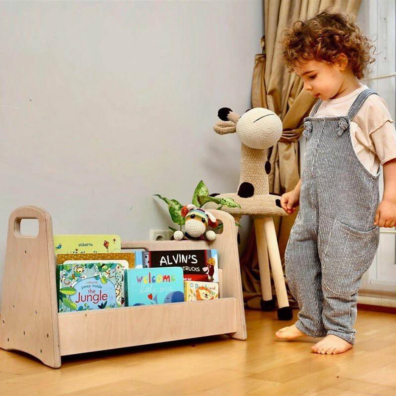 Child Playing With Toys Next to Kidodido Montessori Bookshelf Organizer