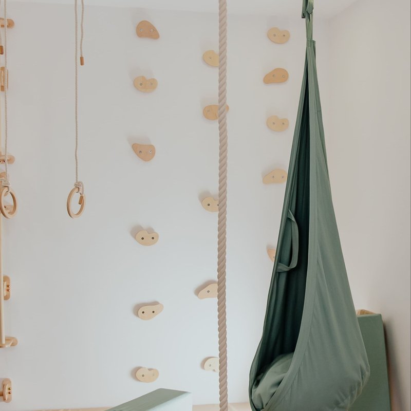 Climbing Holds – wall hold layout beside an optional pod swing