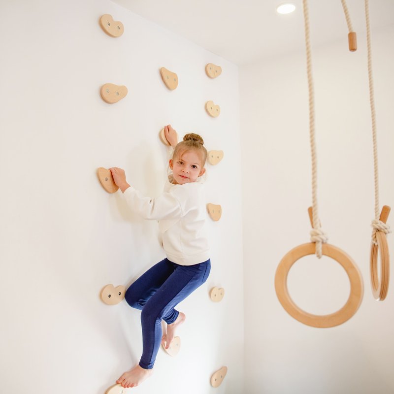 Climbing Holds – kid climbing holds beside gymnastic rings