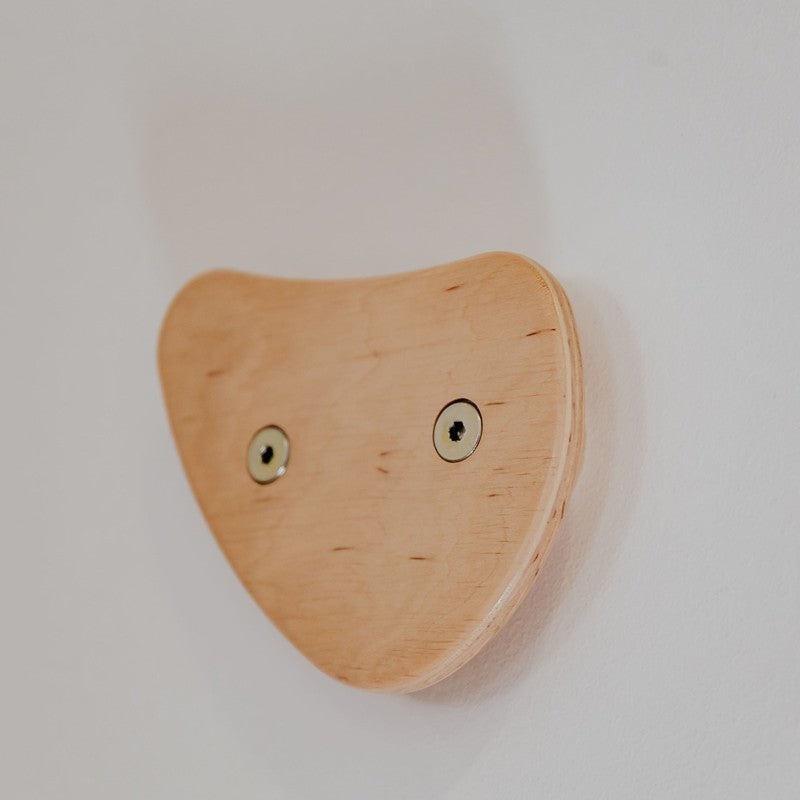 Climbing Holds – close-up of a rounded triangular wooden hold
