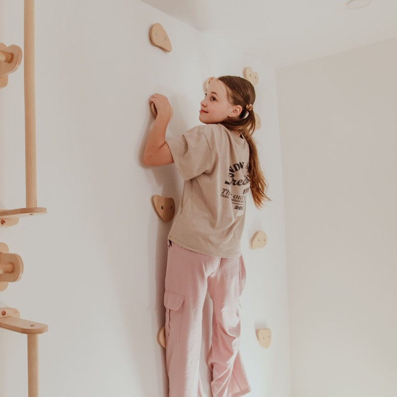 Climbing Holds – kid reaching for a wooden wall hold