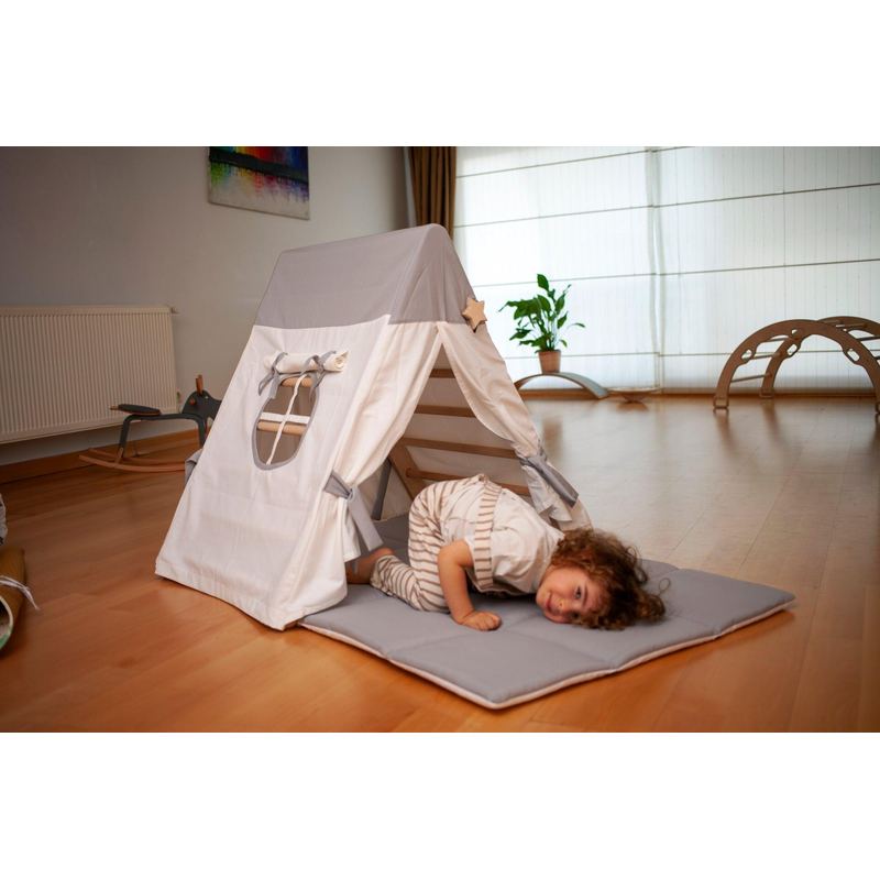 climbing triangle with boy on a mat