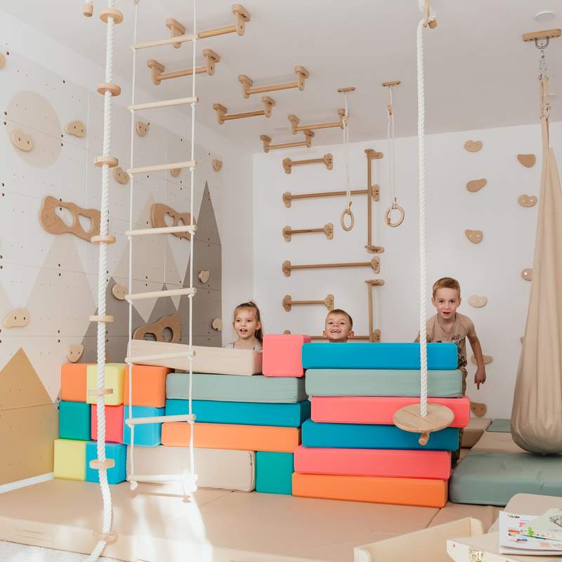 Wood and Hearts Climbing Wall Playground – kids with optional foam blocks in front of the climbing wall