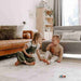 Boy and girl sitting together on the Dakota Ivory Shwally Playmat