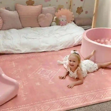 Baby crawling on the cushioned Dakota Rose Shwally Playmat